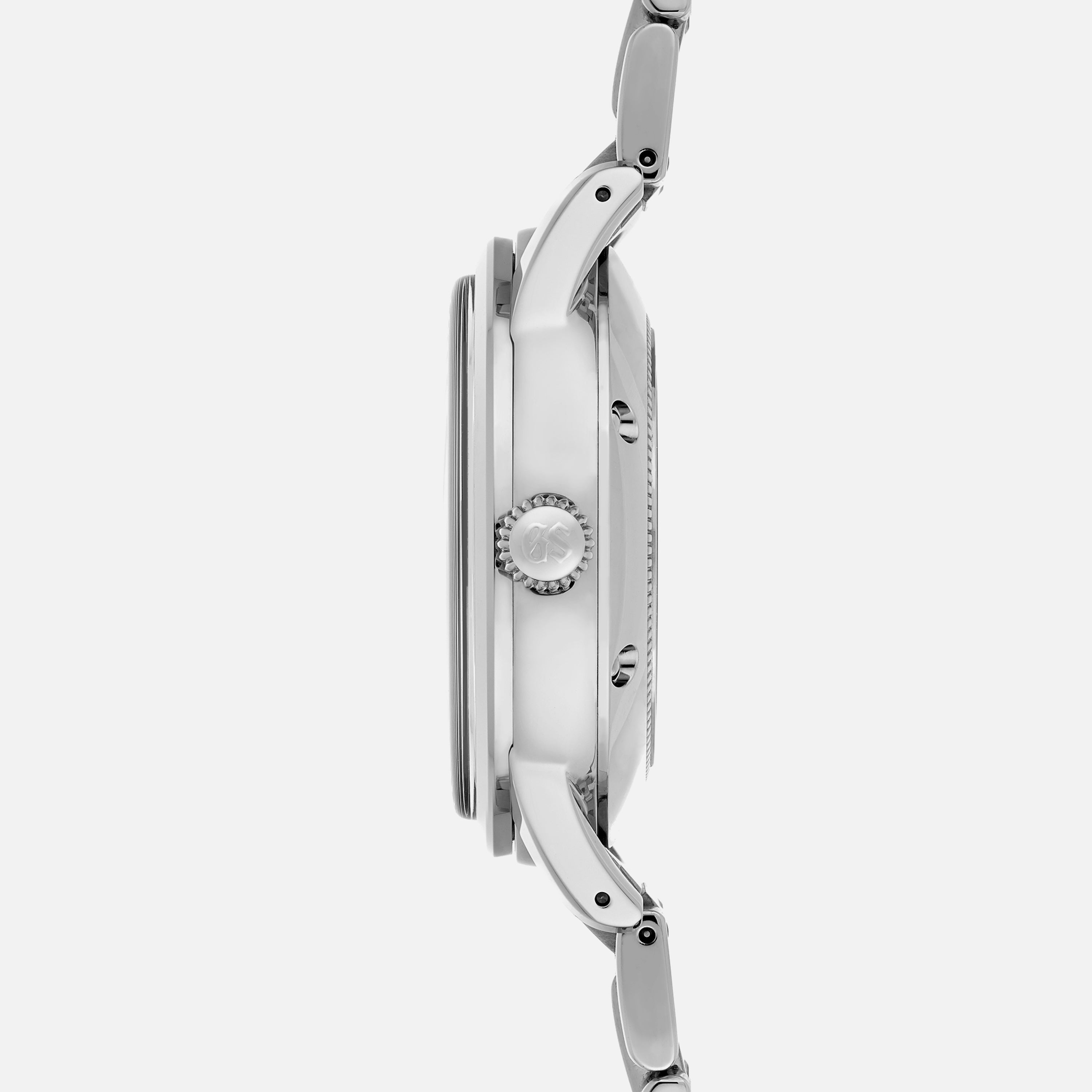 Side profile of the Grand Seiko Automatic GMT SBGM239 Limited Edition For HODINKEE, featuring its silver metal band, prominent crown, and case thickness against a plain white background.