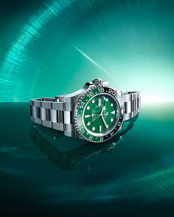 Rolex GMT-Master II with green dial showcased on a deep green radial gradient background