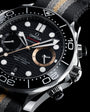 Omega Seamaster Diver chronograph with black dial, white hour markers, rose gold subdial, and black fabric strap.