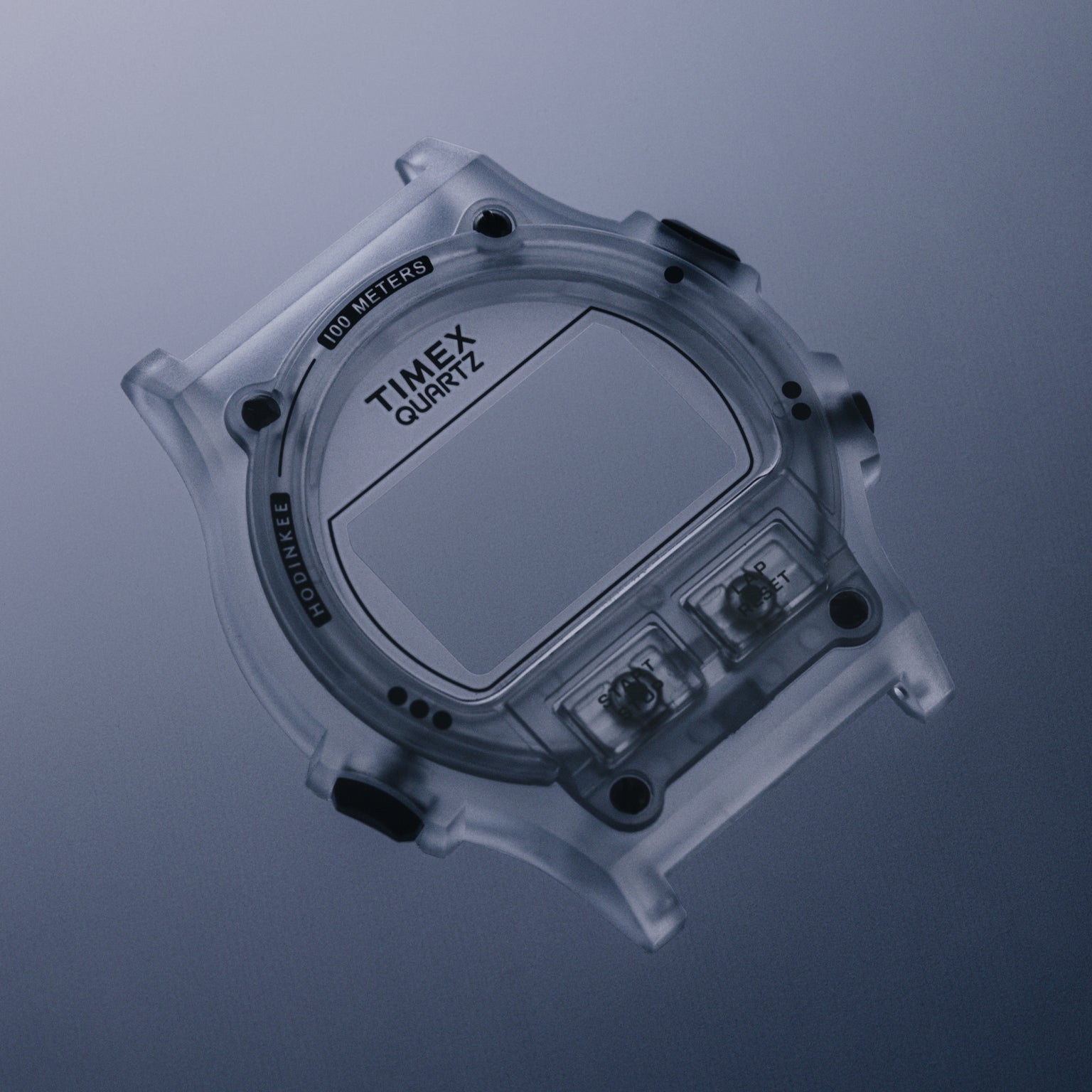 Clear translucent digital watch with square face, "TIMEX QUARTZ" dial, two side buttons, and "100 METERS" marking.
