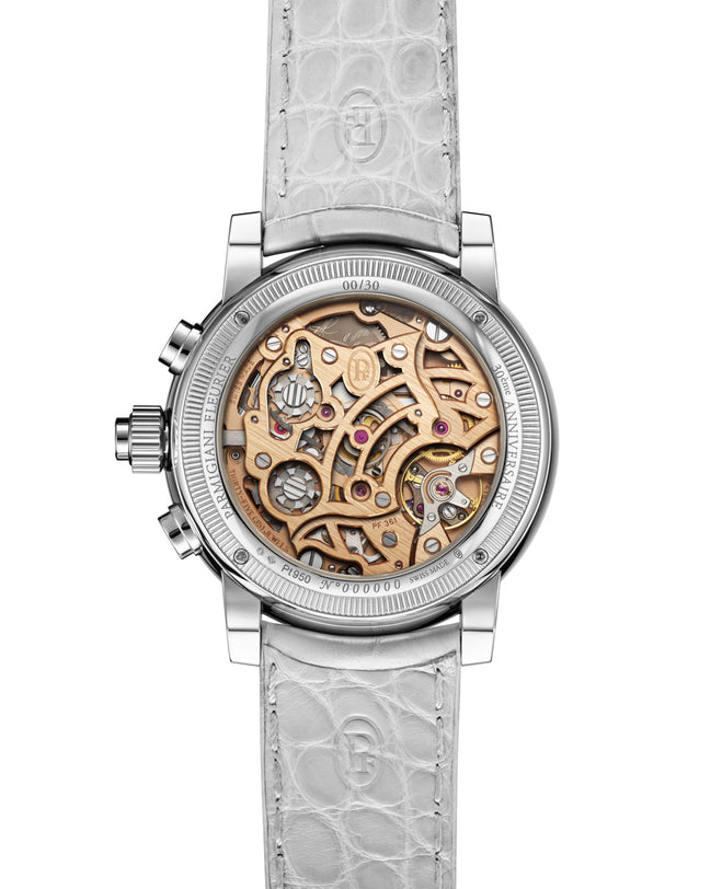 Luxury watch with mechanical components and white strap on a white background