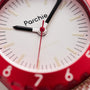 Close-up of a red Parchie Lunar-Time Limited Editions for Hodinkee 32 wristwatch displaying the time as 9:05:31.