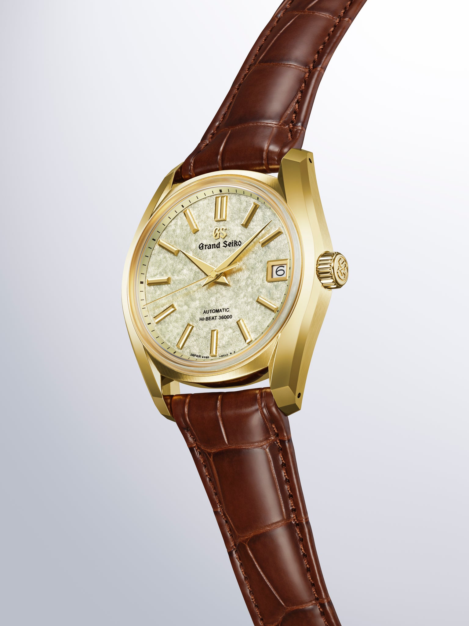 Grand Seiko Hi-Beat 36000 automatic watch with gold-tone case, cream dial, gold hour markers, date window, and brown crocodil