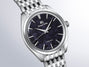 Grand Seiko watch with silver stainless steel bracelet, dark blue dial, and applied hour markers.