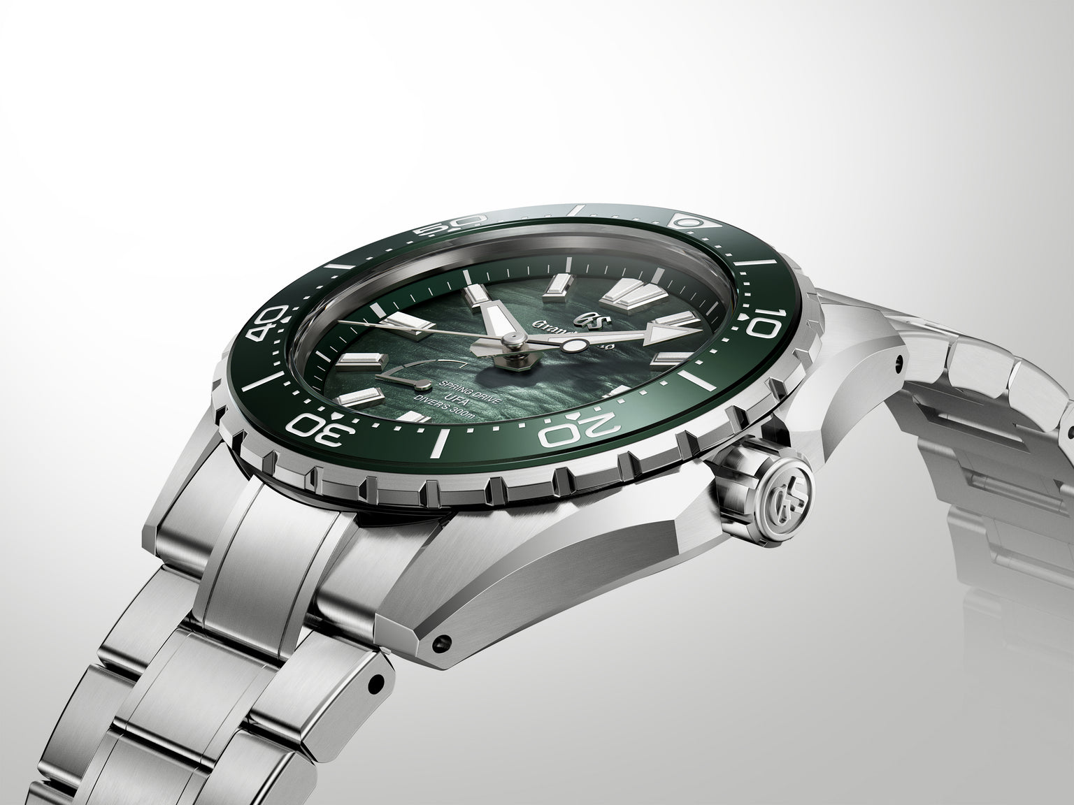 Stainless steel dive watch with green sunburst dial, black bezel, and matching bracelet.