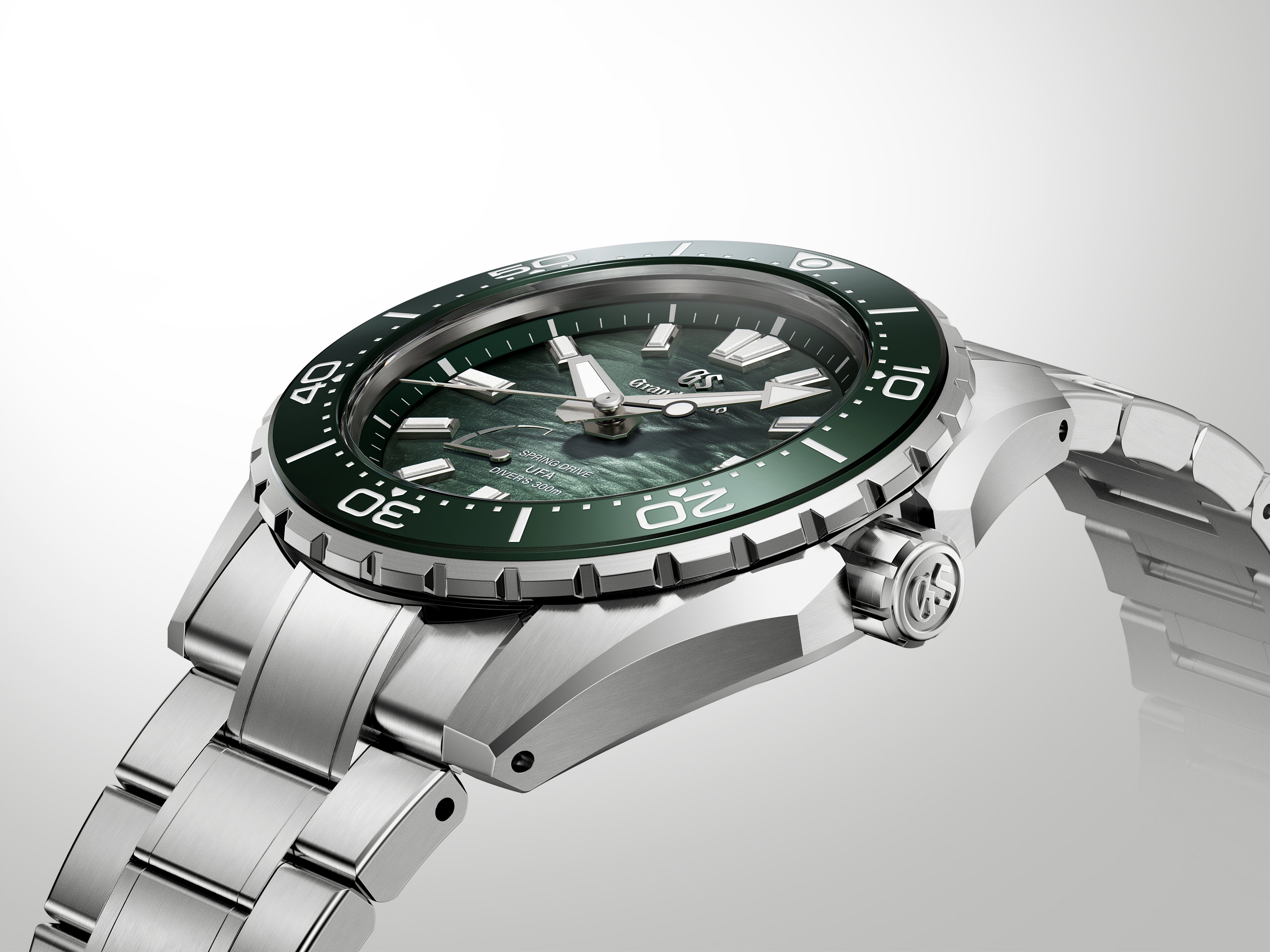 Stainless steel dive watch with green sunburst dial, black bezel, and matching bracelet.