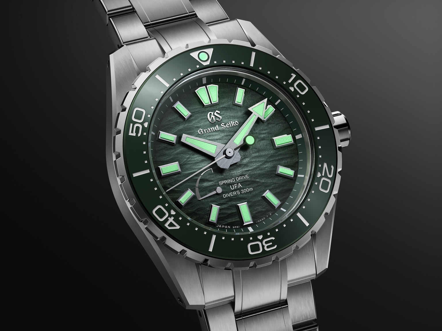 Stainless steel diver watch with dark green dial, luminous hour markers and hands, unidirectional bezel, and three-link brace