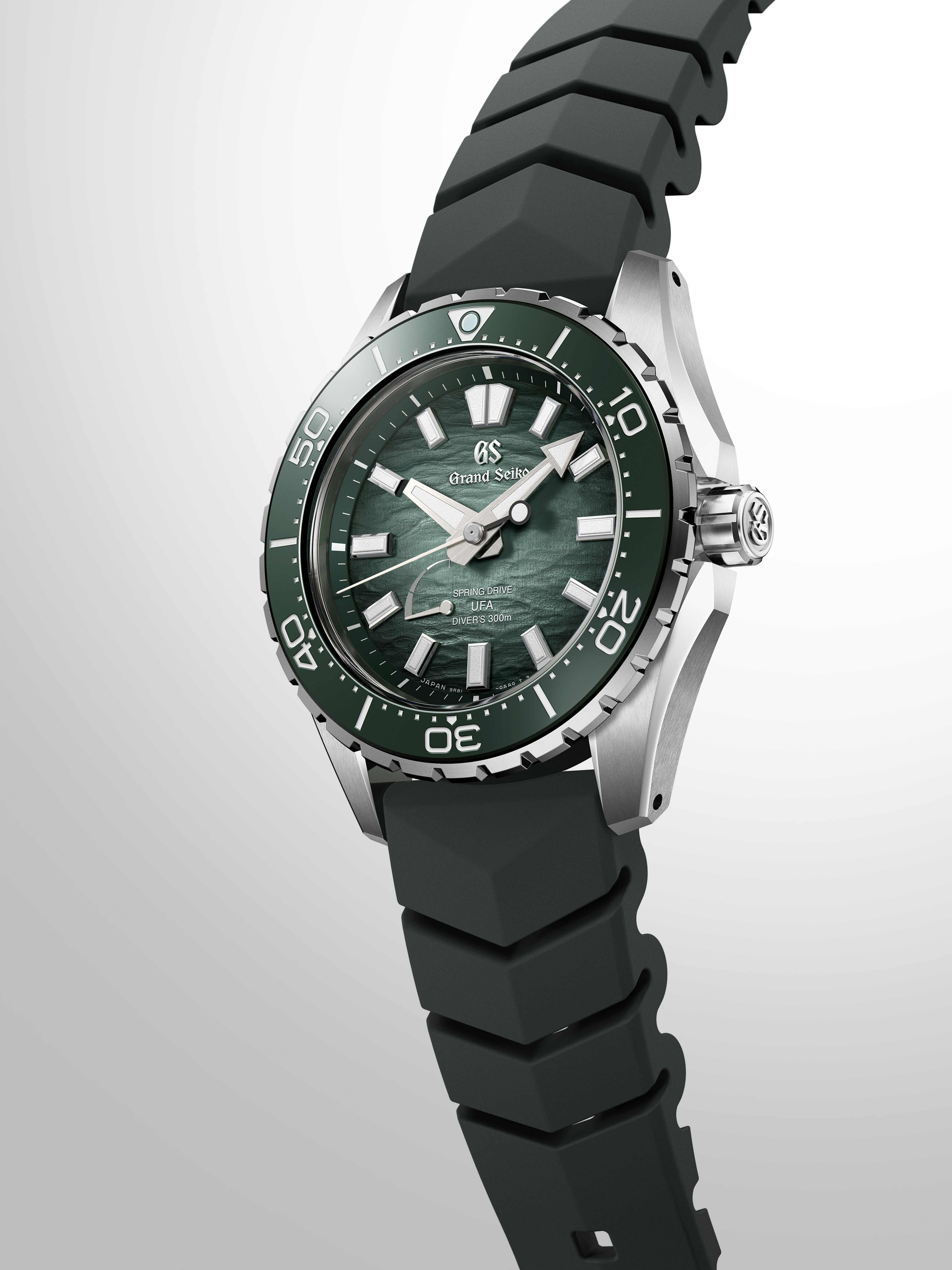 Grand Seiko diving watch with green dial, steel case, black rubber strap, and rotating bezel.