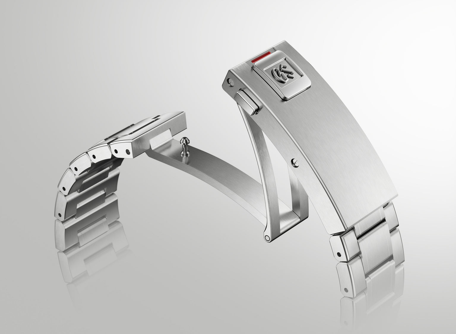 Silver stainless steel dive watch with rectangular case, metal bracelet, and red accent on buckle clasp.