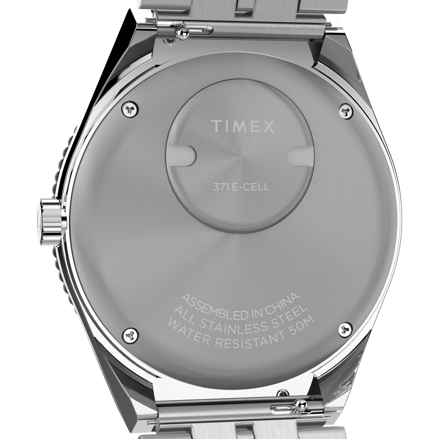 Close-up of the back of a Timex Q Timex GMT watch, featuring engraved assembly details, stainless steel construction, 50-meter water resistance, and a visible battery compartment.