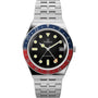 The Timex Q Timex GMT watch features a silver metal band, black dial, date display, blue and red bezel, large luminous markers and hands, with "Q TIMEX" and "GMT QUARTZ" on the face.