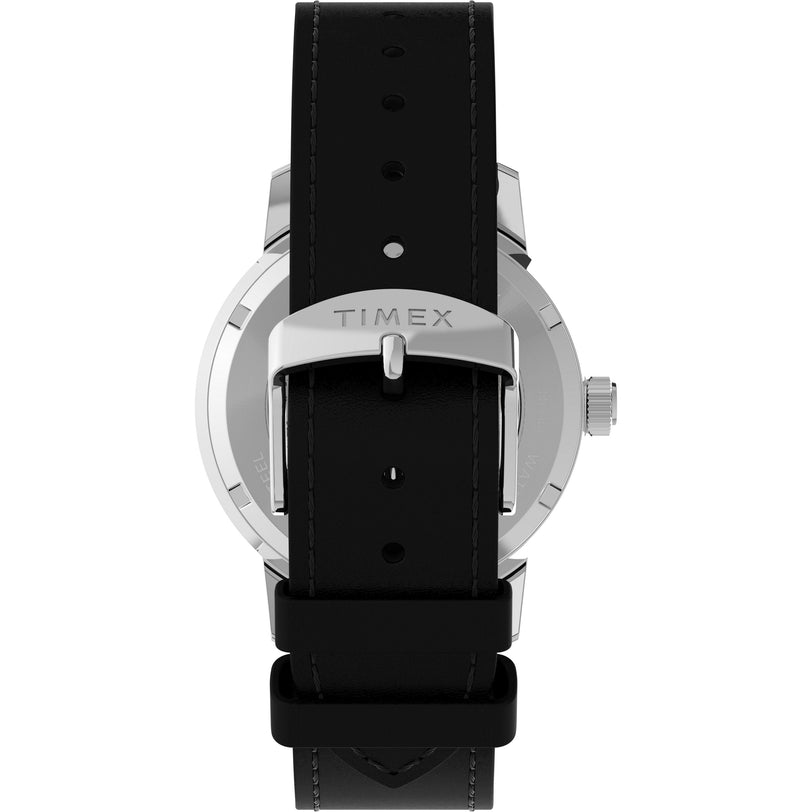 A close-up shows the back of a Timex Marlin® Automatic wristwatch with a black leather strap and a silver buckle engraved with TIMEX, plus partial views of the case, crown, and domed acrylic crystal.