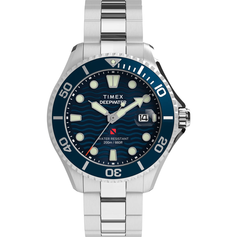 The Timex Deepwater Meridian 200 is a recycled stainless-steel dive watch with a silver case, blue wave-pattern dial, large white markers, date at 3 o’clock, and blue numeral-marked bezel. Water resistant to 200m.