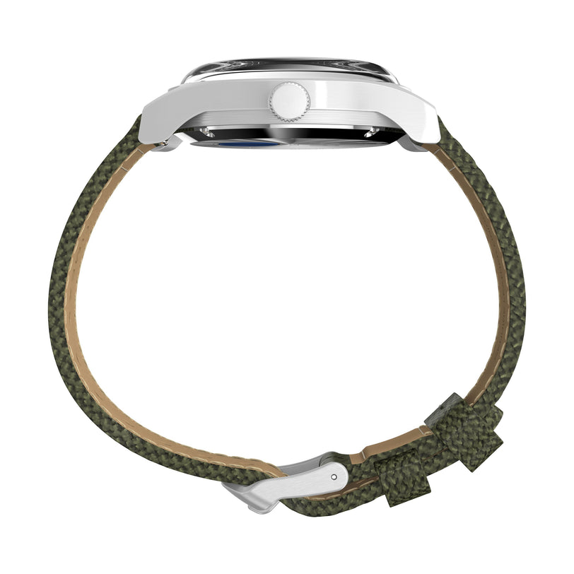 A side view of the Timex G SS AU SW MK1 40 BLK DL GRN STP 25 shows its stainless steel case, side crown, and green woven strap with buckle, highlighting the watch’s refined military style.