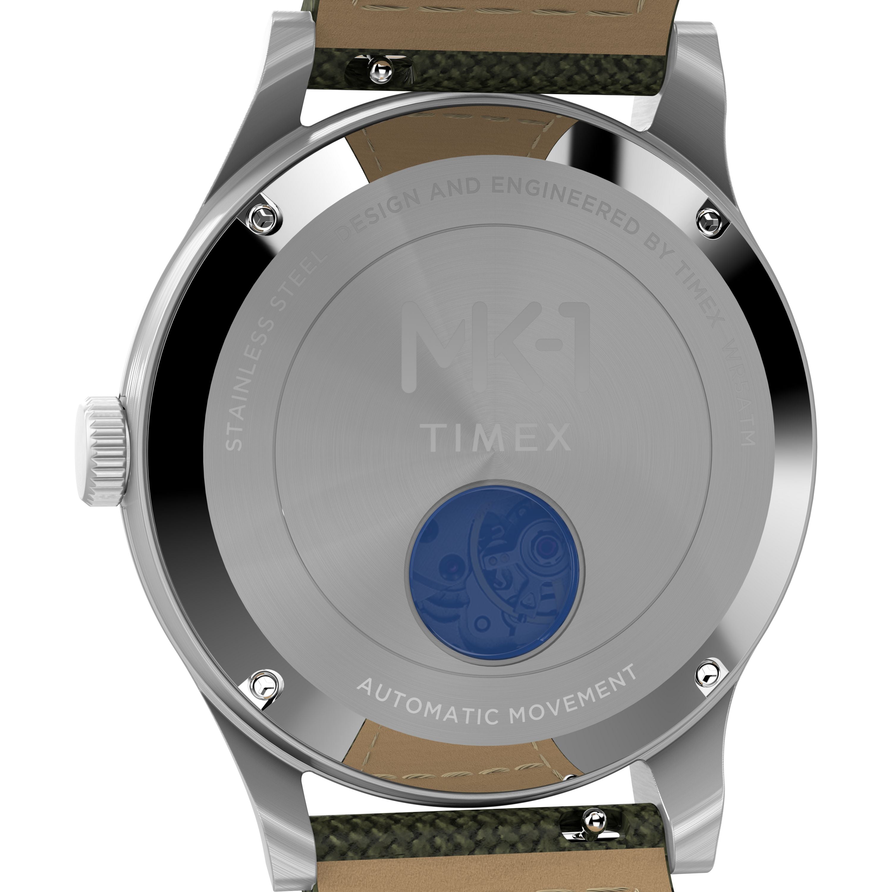 The Timex G SS AU SW MK1 40 BLK DL GRN STP 25 features a stainless steel case with engraved text, a blue-tinted window revealing the Japanese automatic movement, and green textile plus tan leather straps in a military style.