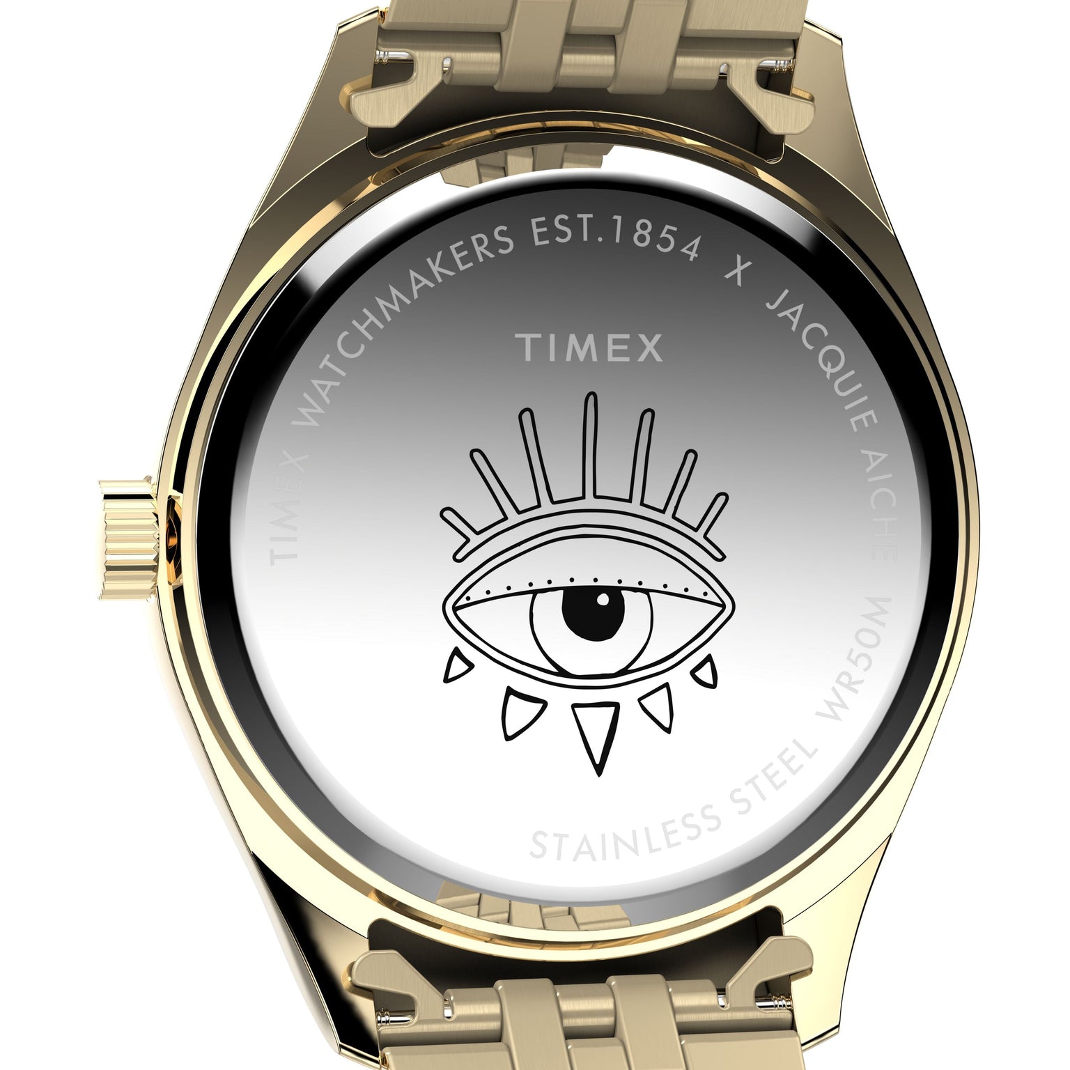 The back of the Timex x Jacquie Aiche watch features an engraved eye, radiating lines and dots, plus text: TIMEX WATCHMAKERS EST.1854 X JACQUIE AICHE, STAINLESS STEEL, and WR50M.