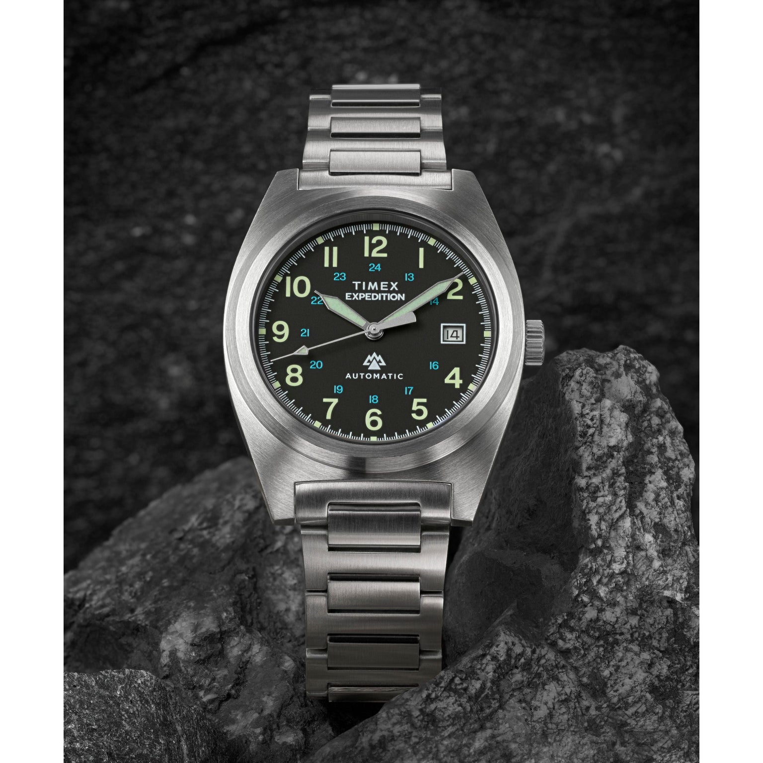 The Timex Expedition® Capstone Automatic watch, crafted with stainless steel and powered by Japanese automatic movement, rests elegantly on a rock.