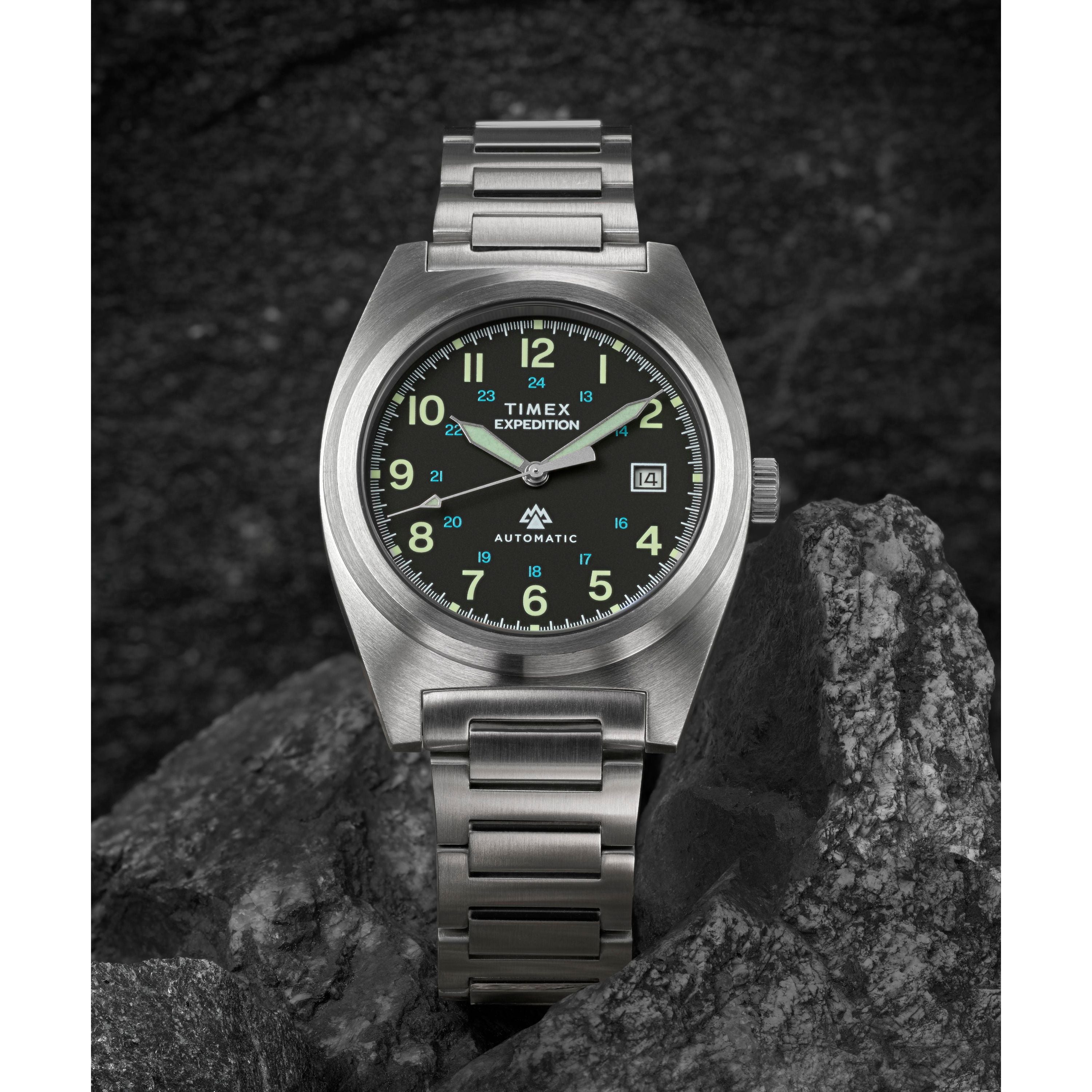 The Timex Expedition® Capstone Automatic watch, crafted with stainless steel and powered by Japanese automatic movement, rests elegantly on a rock.