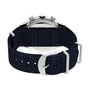 A close-up of the back of a Timex Waterbury Traditional Fly-Back Chronograph, featuring a dark blue woven strap and silver buckle, with engraved brand details visible on the stainless steel watch case.
