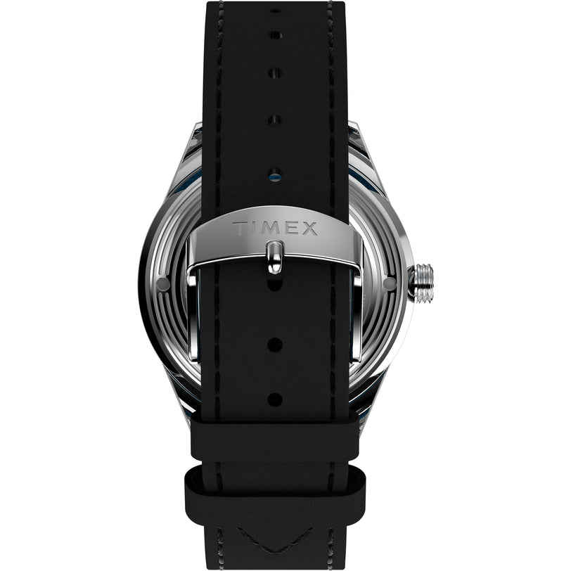 The image displays the back of the Timex x Superman Marlin® Jet Automatic by Timex, featuring a black strap, silver clasp engraved with TIMEX, and metallic case emphasizing its automatic movement.