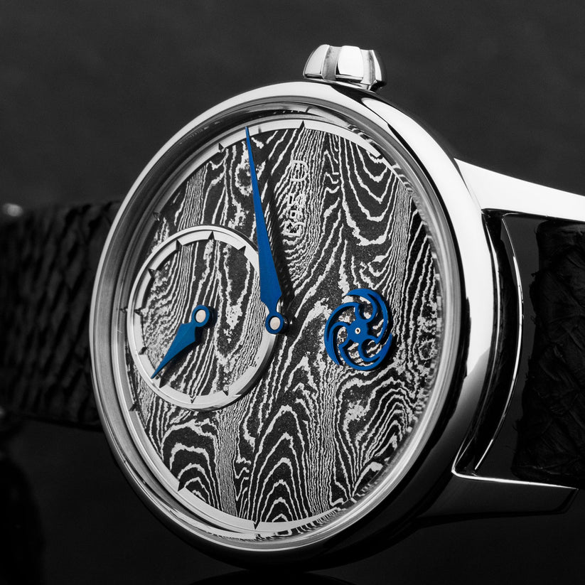 Luxury watch with intricate design and blue accents on a dark background