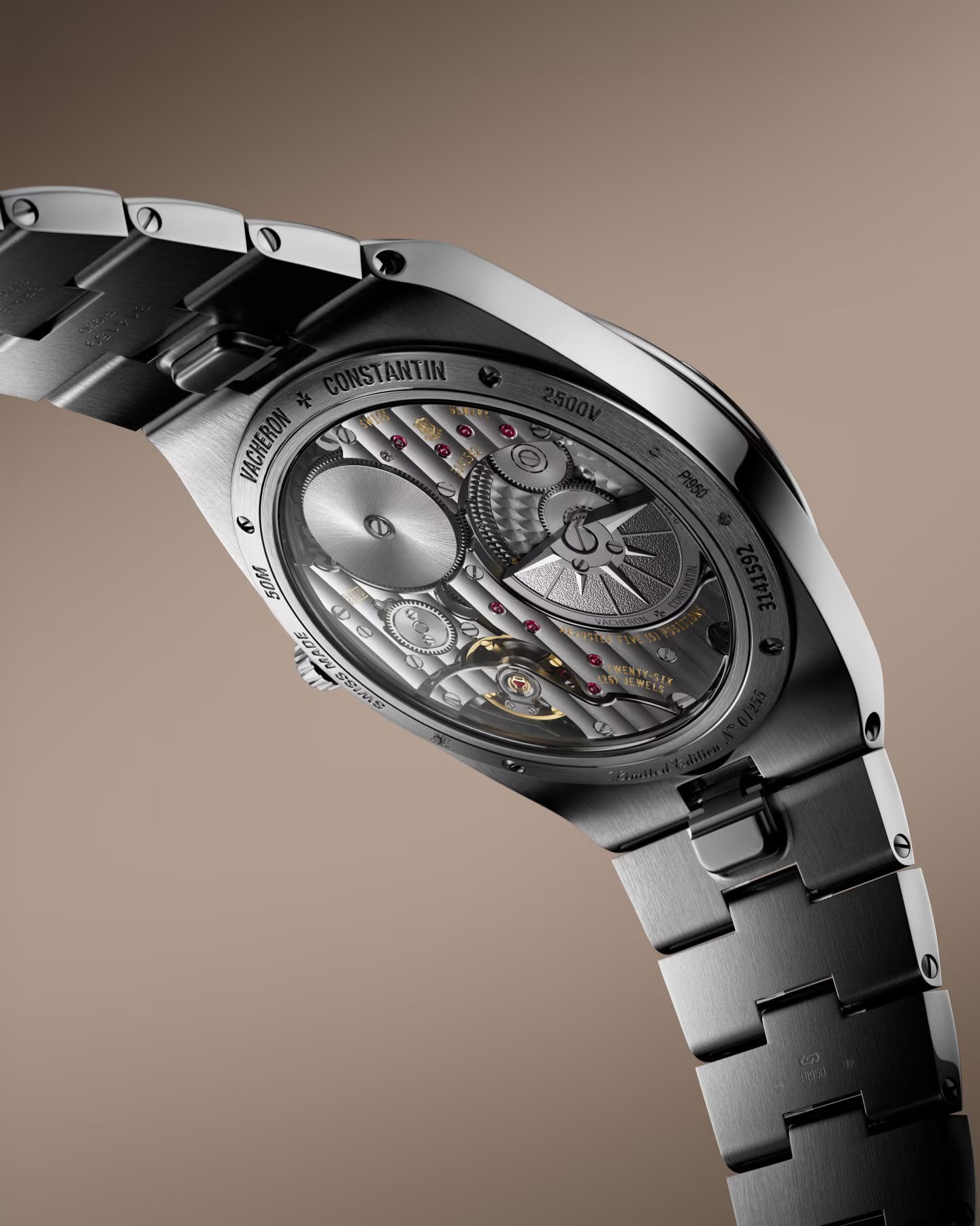 Silver and black automatic watch with exposed mechanism, oval case, and two-tone metal bracelet.