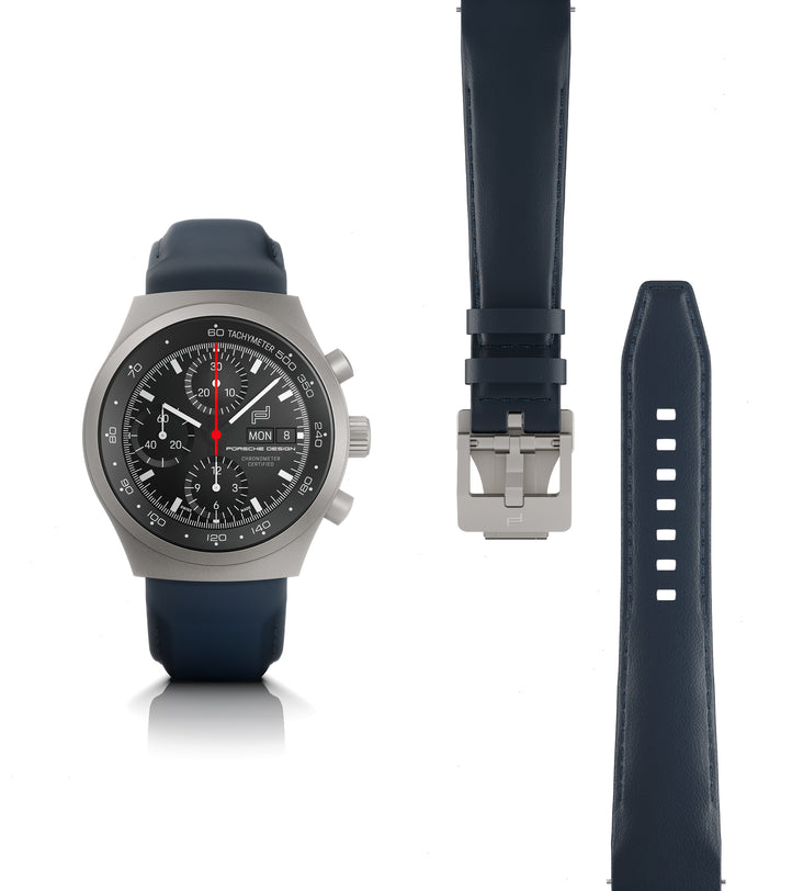 Titanium chronograph watch with black dial, red seconds hand, and dark blue rubber strap shown with buckle and full strap len