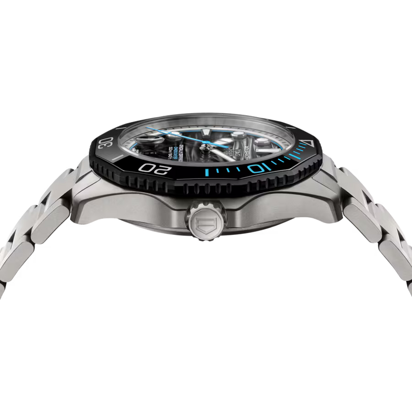Stainless steel sports watch with black and blue bezel, black dial, and metal bracelet displayed at angle.