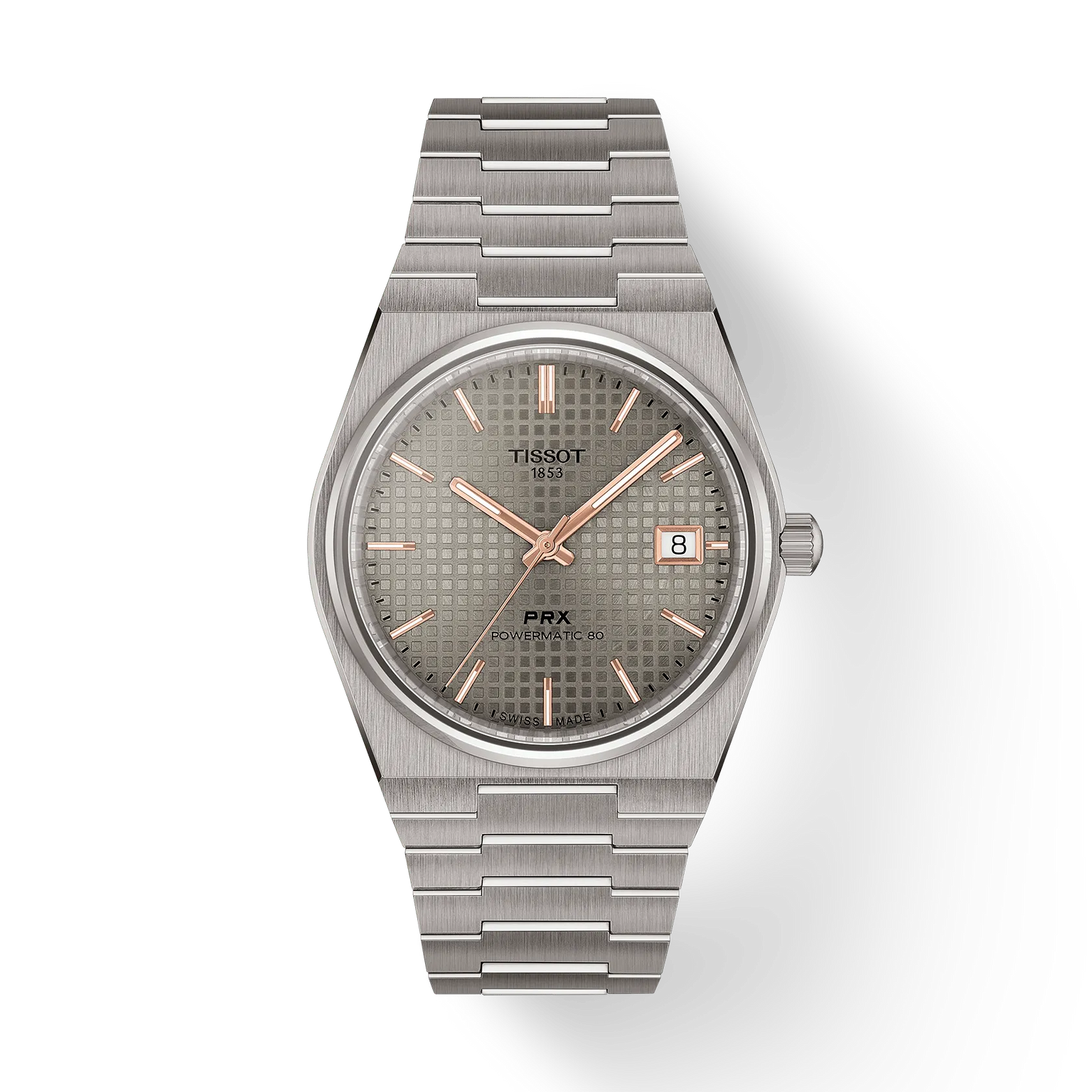 The Tissot PRX 38 features a stainless steel bracelet, silver textured dial, gold markers and hands, sapphire crystal, and a date window at 3 o’clock. The watch is showcased against a plain white background.