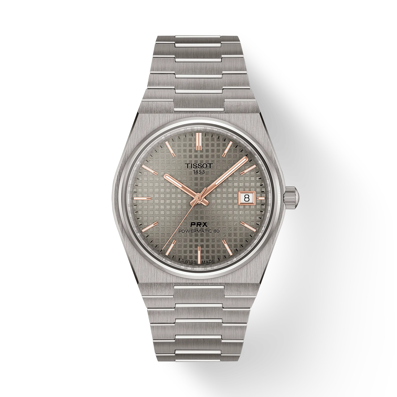 The Tissot PRX 38 features a stainless steel bracelet, silver textured dial, gold markers and hands, sapphire crystal, and a date window at 3 o’clock. The watch is showcased against a plain white background.