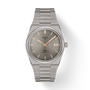 The Tissot PRX 38 features a stainless steel bracelet, silver textured dial, gold markers and hands, sapphire crystal, and a date window at 3 o’clock. The watch is showcased against a plain white background.