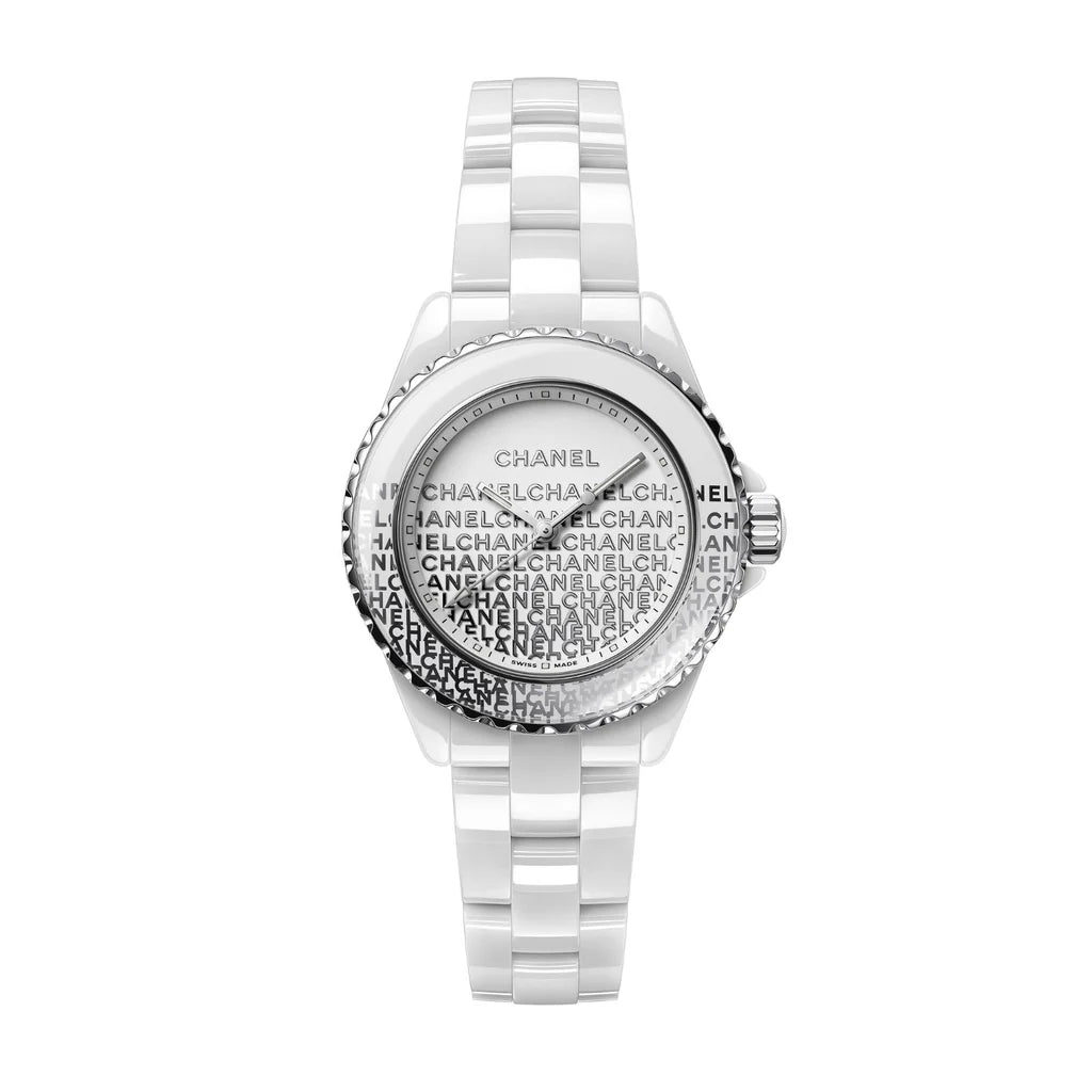 The J12 Wanted de Chanel is a white ceramic wristwatch by Chanel, featuring a steel bezel, a patterned dial with repeated black "CHANEL" text, and a sleek metal-accented bracelet for a modern, highly resistant design.