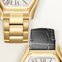 Gold-tone watch with rectangular face and striped dial, shown with interchangeable black leather strap and gold link bracelet