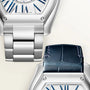 Silver-tone watch with white dial, blue Roman numerals, and matching silver metal bracelet, shown from above with navy leathe