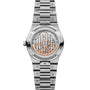 Stainless steel watch with two-tone dial displaying exposed movement, date window, and linked bracelet with brushed finish.