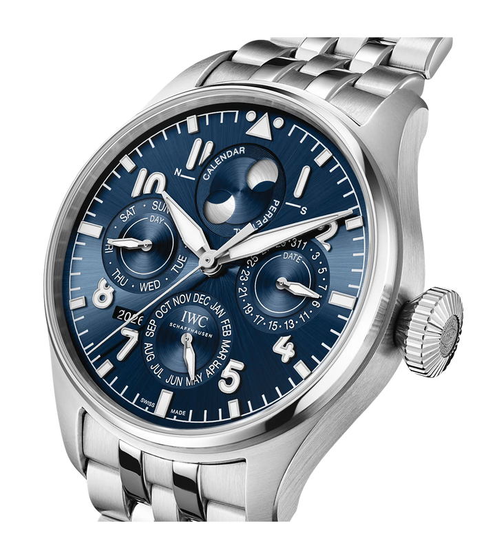 Stainless steel pilot watch with blue dial, perpetual calendar complications, moon phase, and metal bracelet.