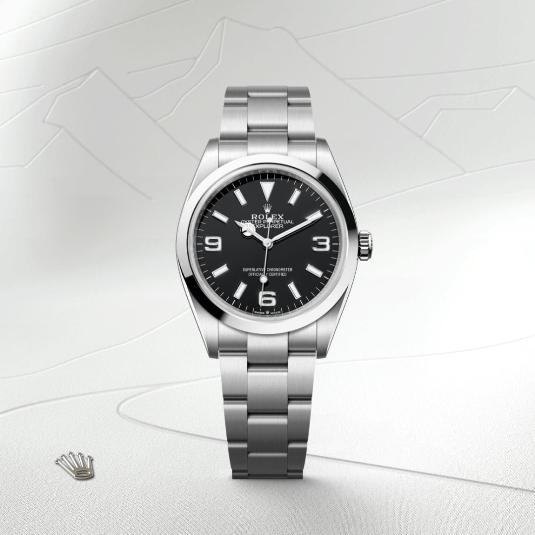 A stainless steel Rolex Oyster Perpetual watch with a black dial, silver hour markers, and a metal bracelet.