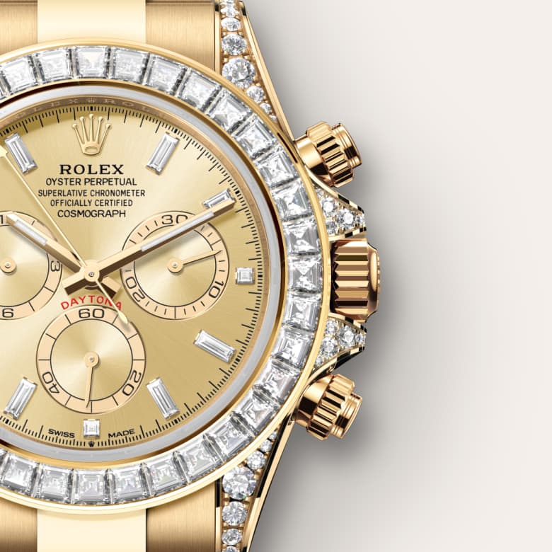 Close-up of a gold Rolex Daytona watch with diamond bezel and champagne dial.