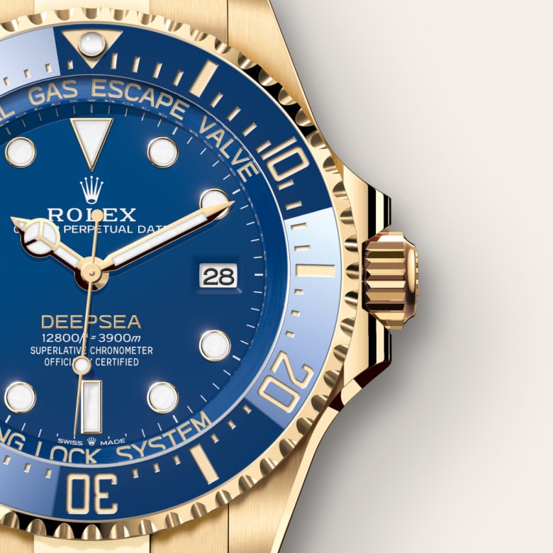 Close-up of a gold Rolex Deepsea watch with a blue dial and date display at the 3 oclock position.