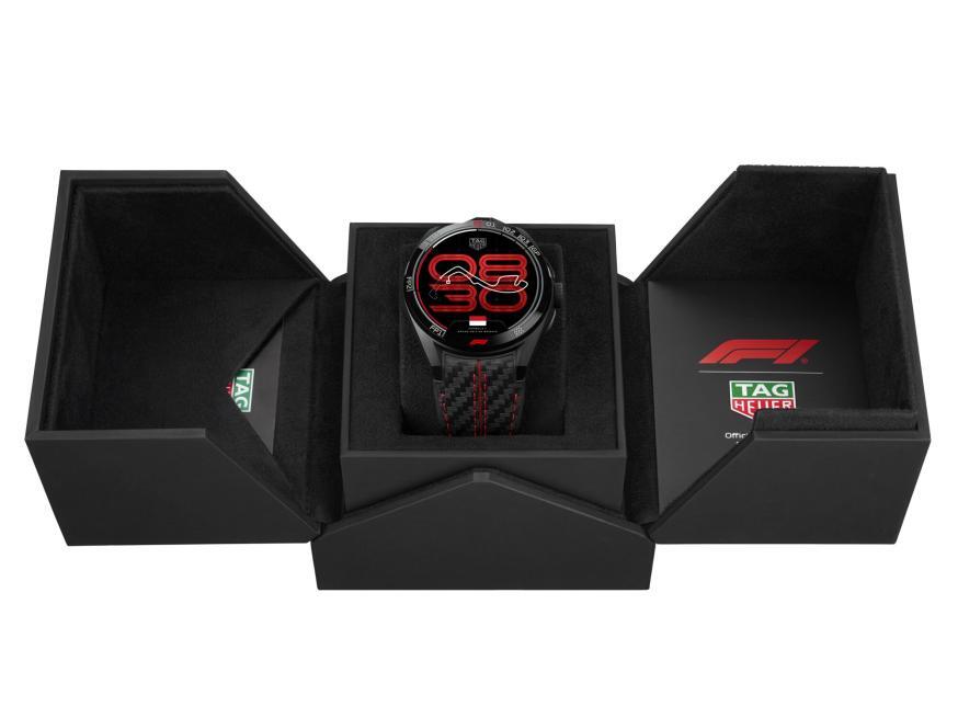 Luxury watch in a black box with visible brand logos on a white background