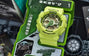 Neon yellow-green digital sports watch with analog dial displayed in protective packaging.