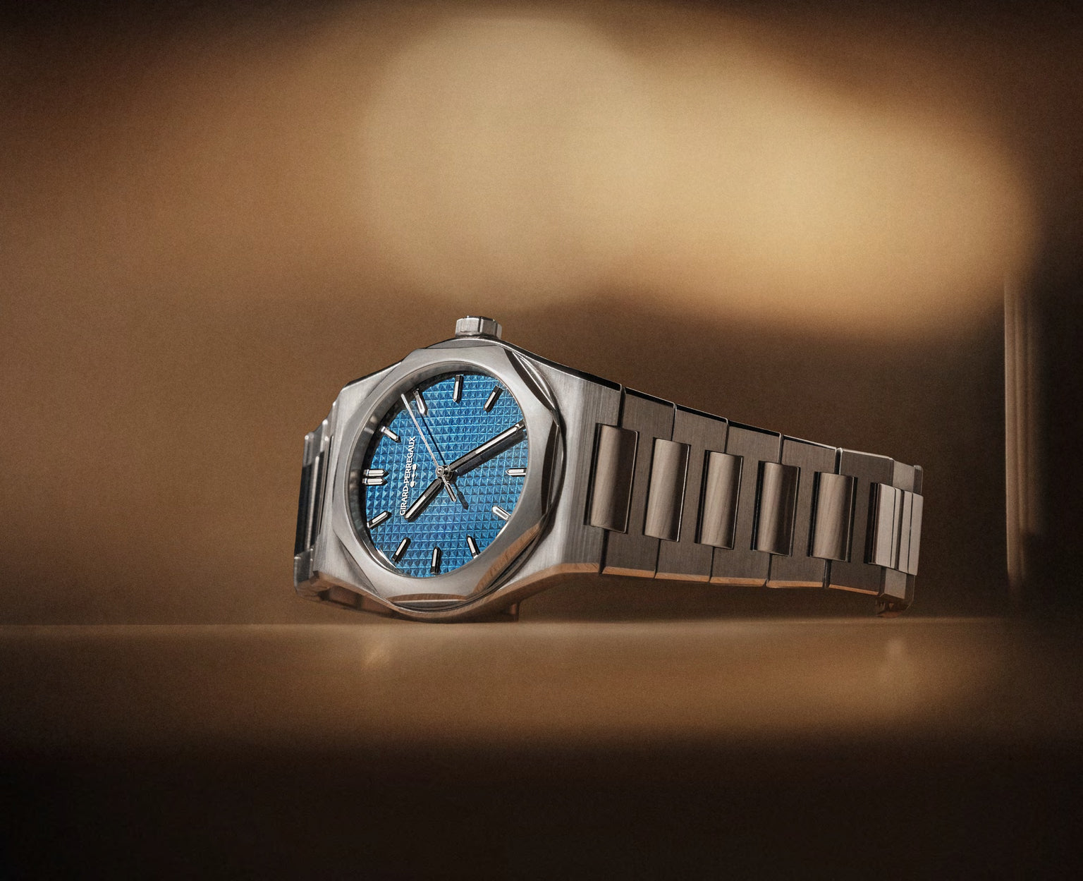 Silver watch with blue face on a brown background