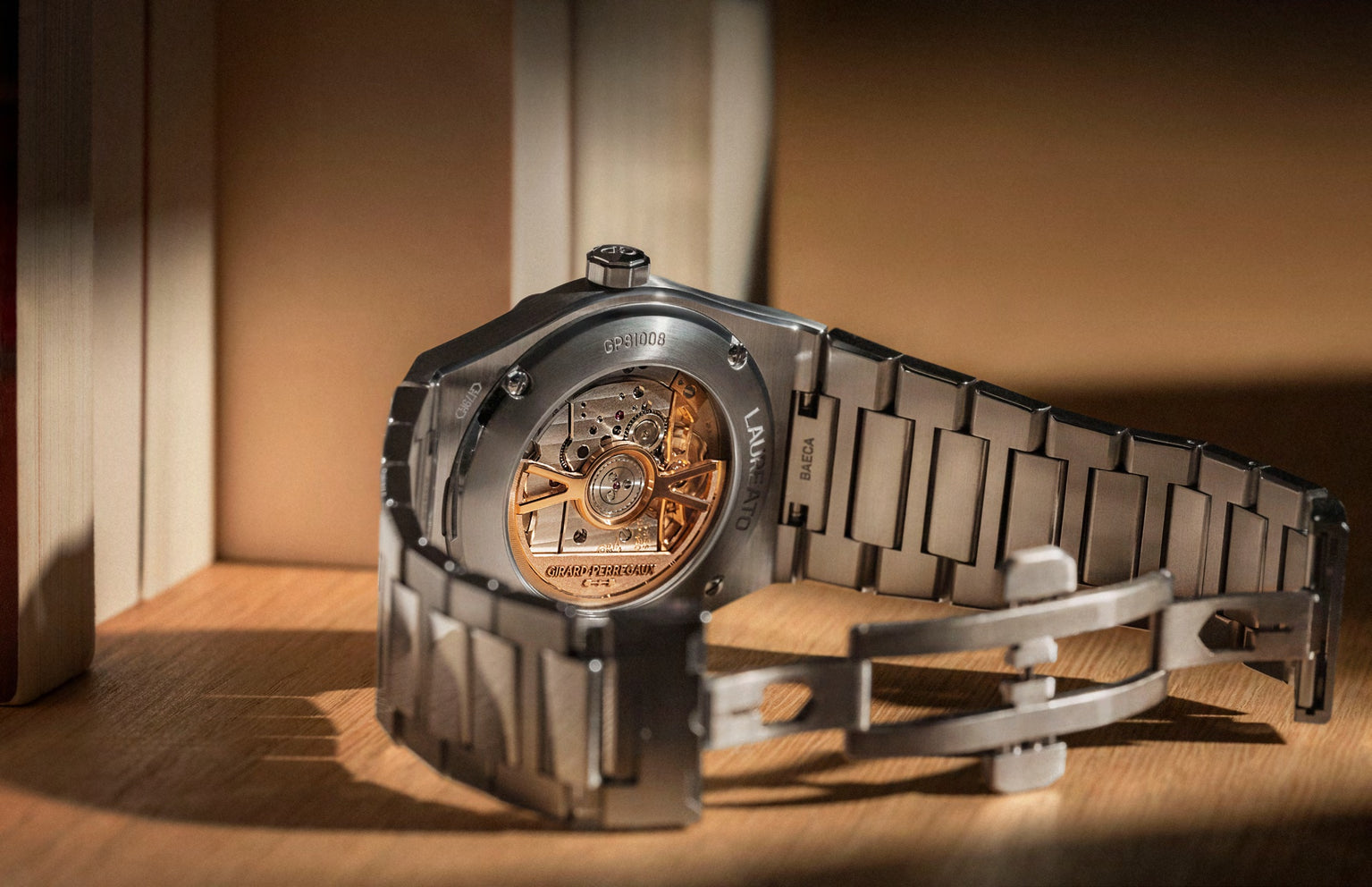 Luxury watch with a metallic band on a wooden surface