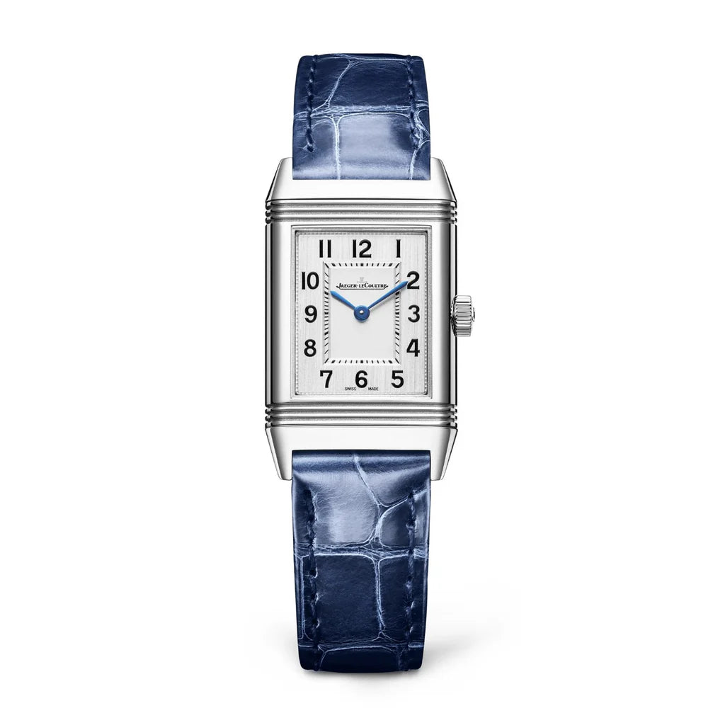 The Jaeger-LeCoultre Reverso Classic Monoface is a rectangular stainless steel watch with a white dial, blue hands, black Arabic numerals, a textured blue leather strap, and precise quartz movement.