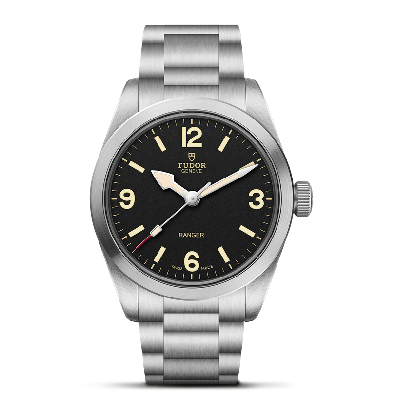 The TUDOR Ranger features a stainless steel case, black dial with bold white numerals at 3, 6, 9, and 12 o’clock, luminous hands, and a brushed metal bracelet. Its minimal design makes it a classic timepiece.