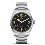 The TUDOR Ranger features a stainless steel case, black dial with bold white numerals at 3, 6, 9, and 12 o’clock, luminous hands, and a brushed metal bracelet. Its minimal design makes it a classic timepiece.