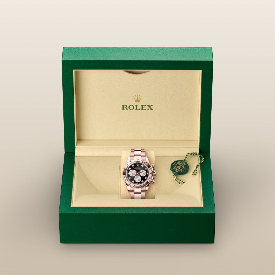 A Rolex watch with a black dial in a green and beige Rolex box, accompanied by a green tag.