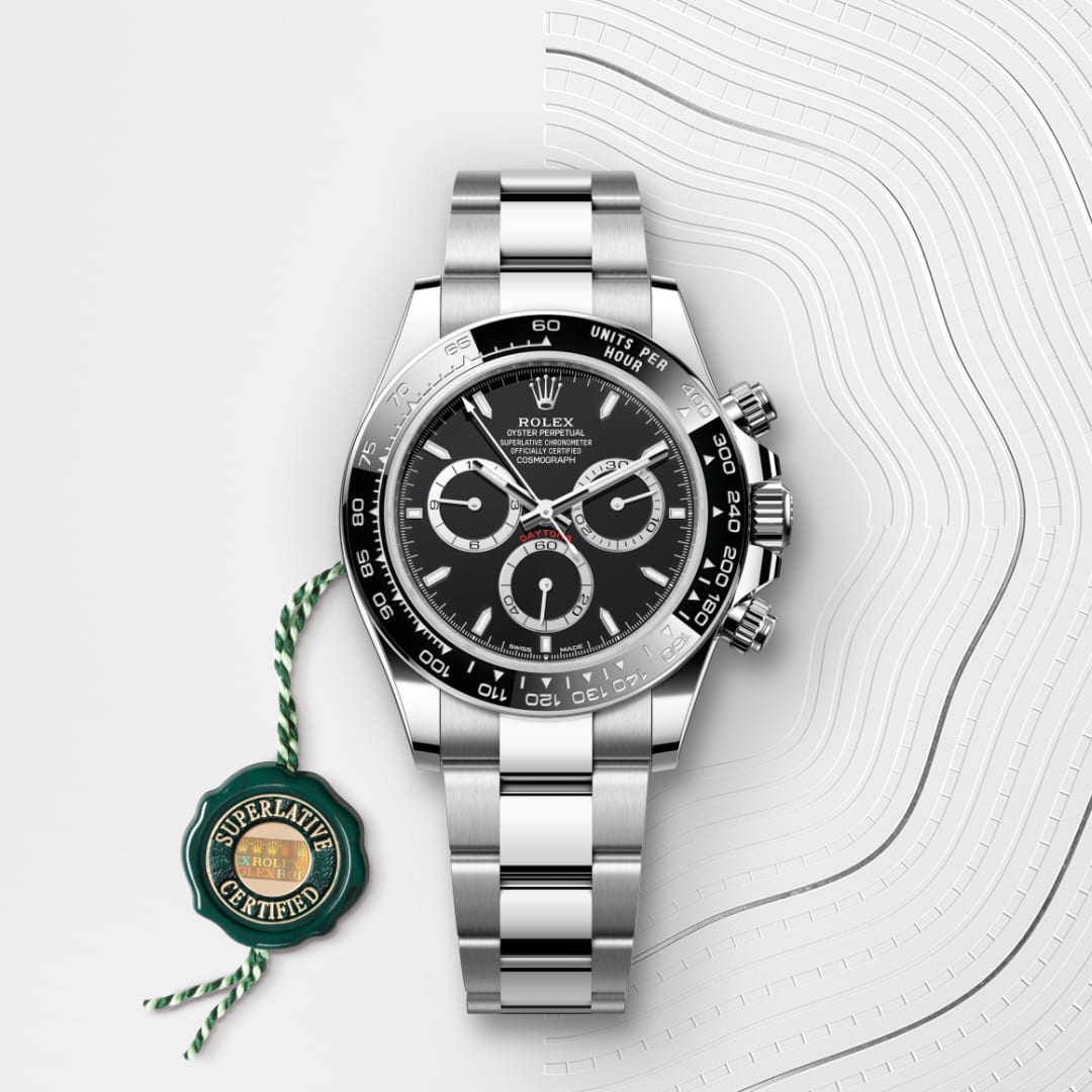 A Rolex Daytona watch with a black dial and stainless steel band, displayed with a Superlative Certified tag.