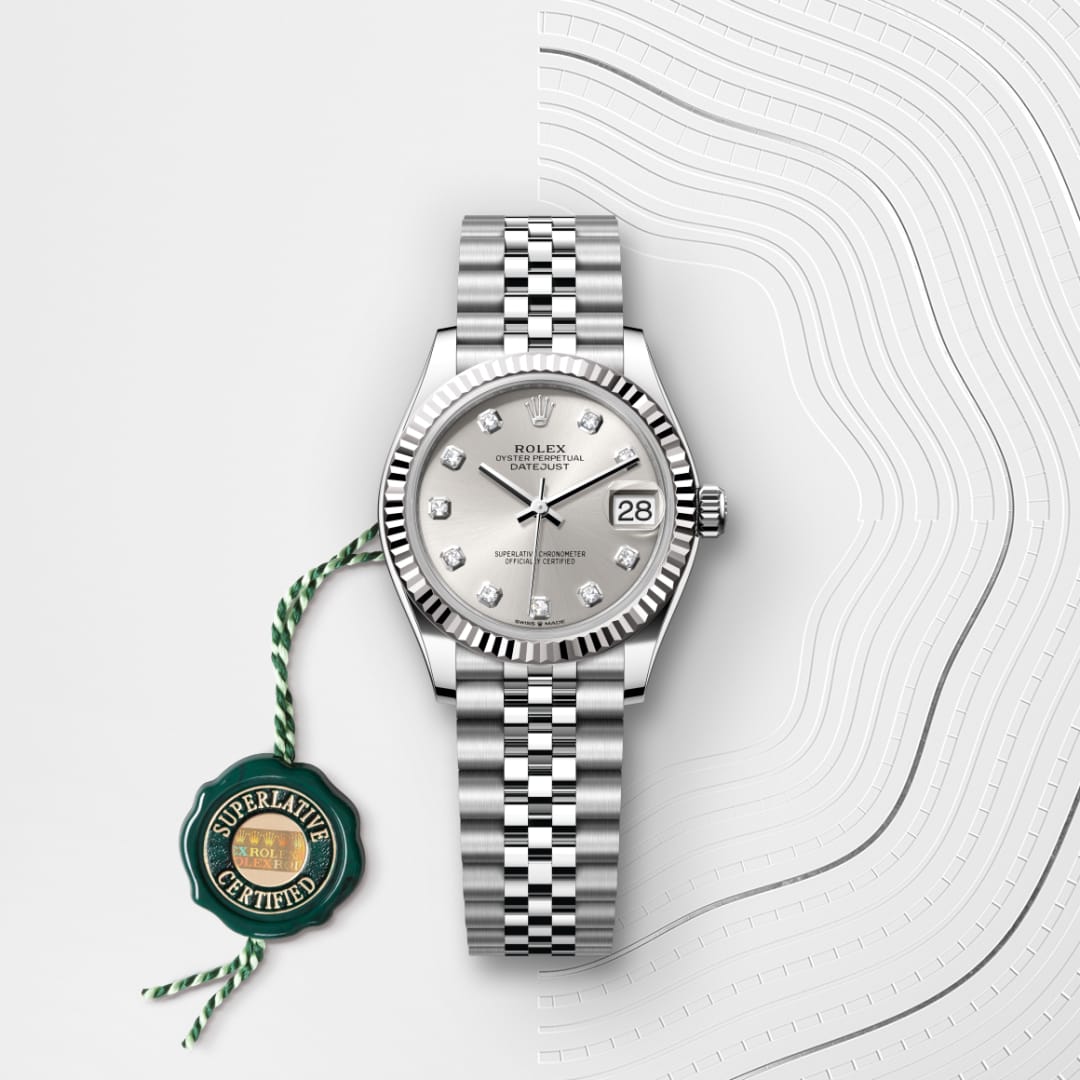Silver Rolex watch with diamond markers and date, shown with a green Superlative Certified tag on a white background.