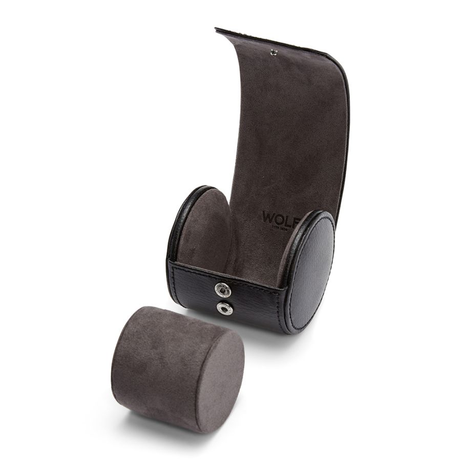 Dark gray suede watch roll with cylindrical storage compartment and detachable cushioned pad, branded with Wolf logo.